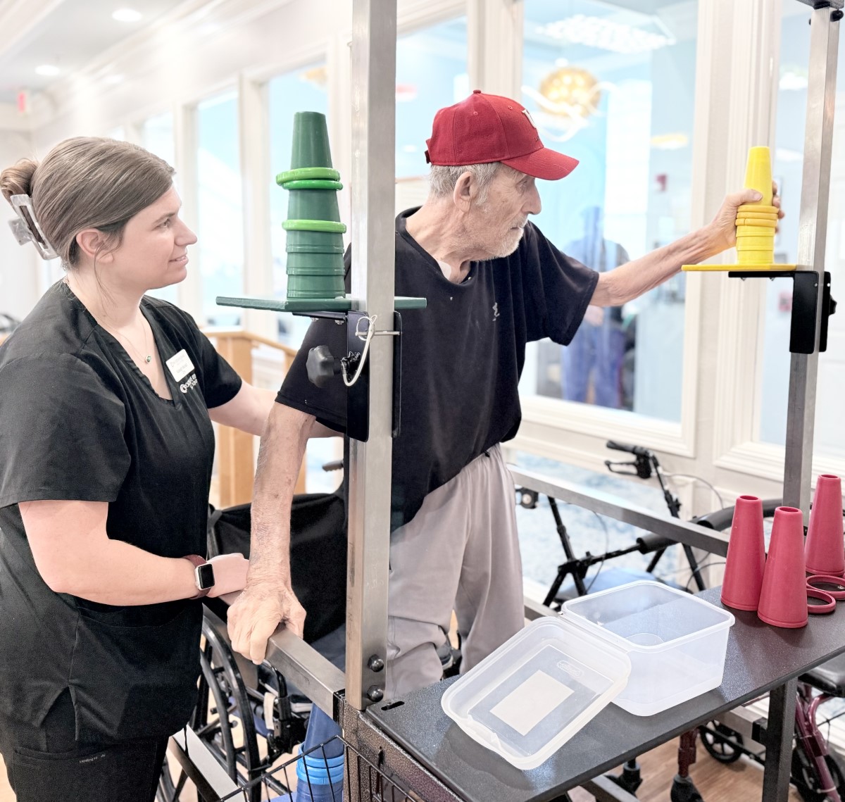 man standing doing occupational therapy at nursing home with female nurse in GreenAcres Place in Bossier City, LA