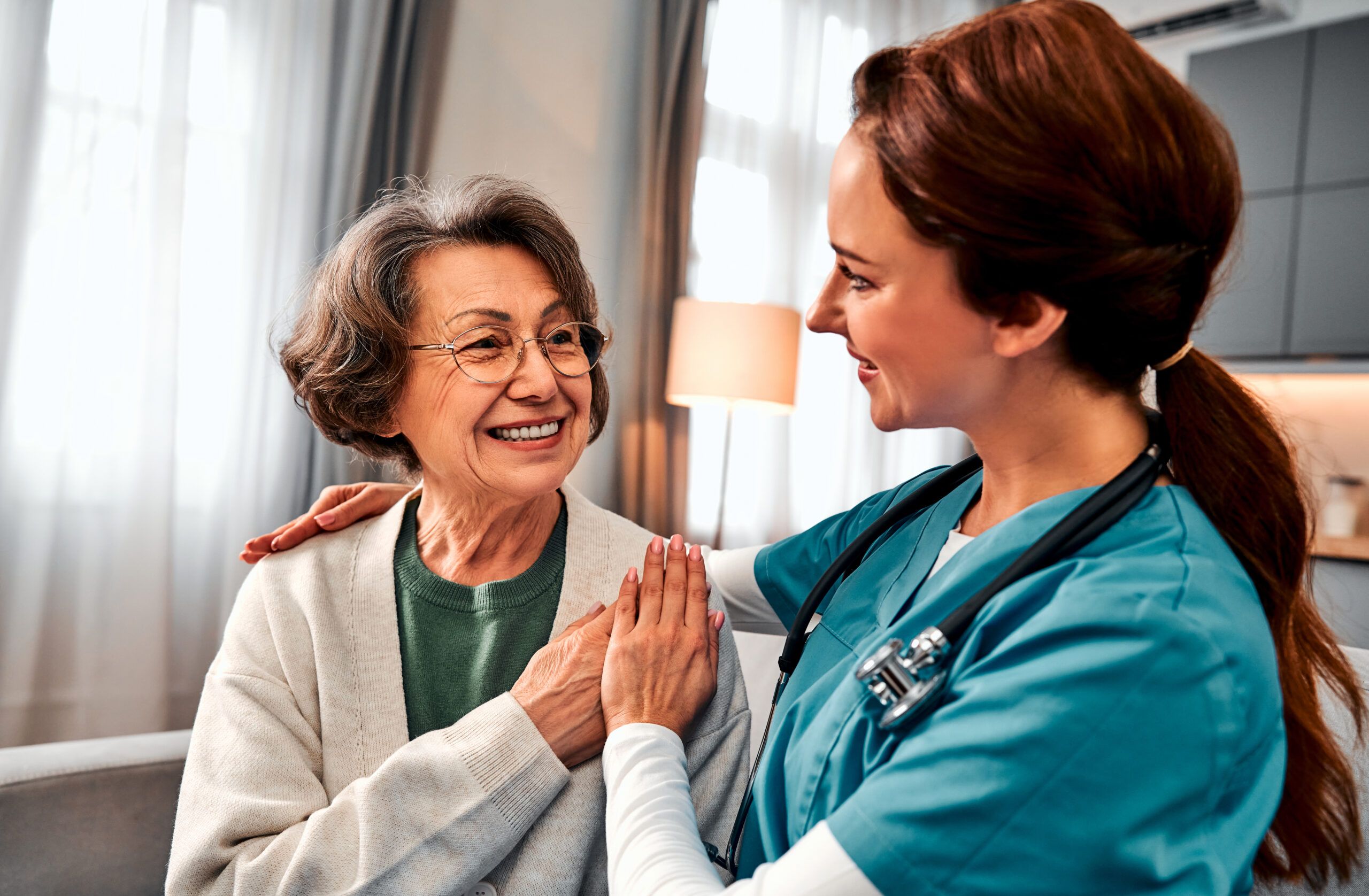 Nurse discusses stroke recovery rehabilitation with an older woman at a nursing home in GreenAcres Place in Bossier City, LA