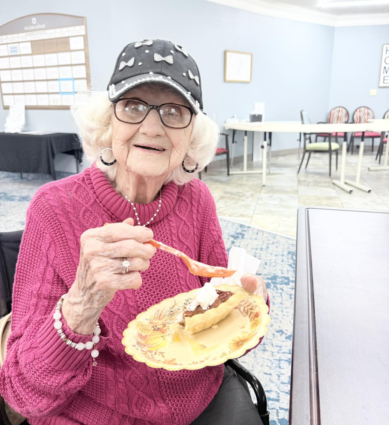 Resident at Pilgrim Manor Skilled Nursing & Rehab enjoying a slice of pie made by the chef in the dining room in GreenPlace Acres in Bossier City, LA